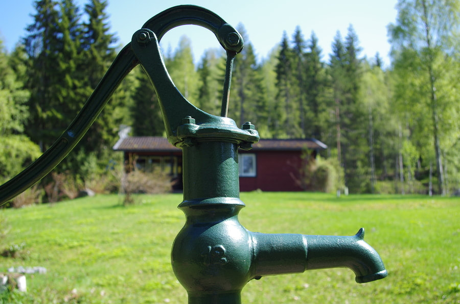 a green water well pump